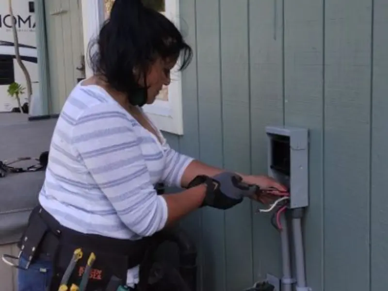 Licensed electrician wiring an exterior subpanel in Bountiful